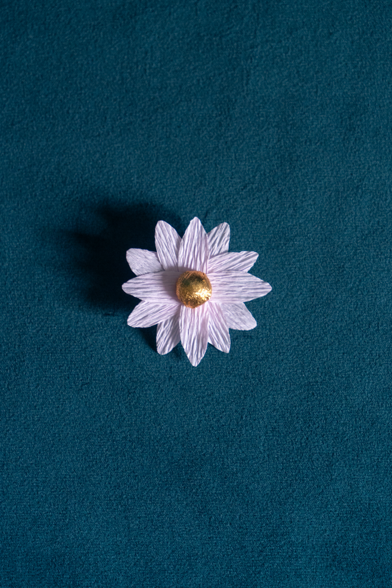 Broche Marguerite de Maison Tessier couleur Quartz violet coeur Or, sur tissus velour émeraude